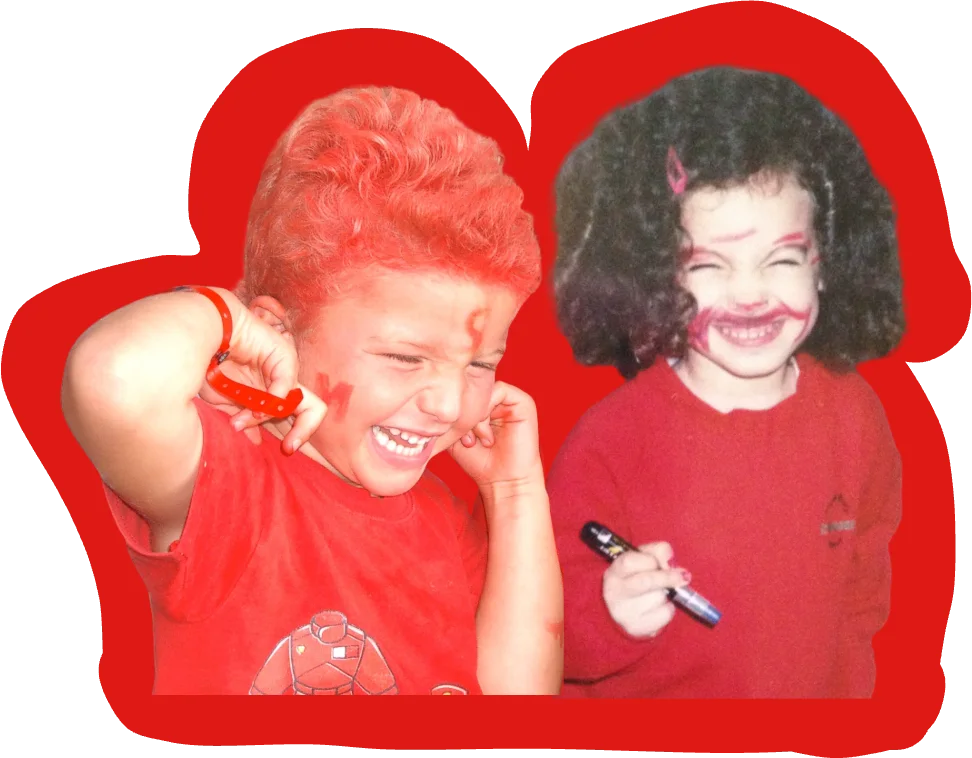 Giovanna and Hugo as kids, both dressed in red